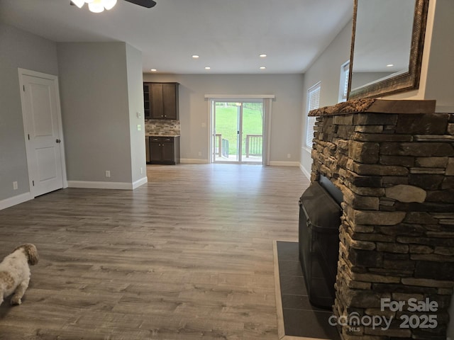 119 Tryon View Dr, Flat Rock, NC 28731 - unfurnished living room with a ceiling fan, wood finished floors, a wood stove, and recessed lighting