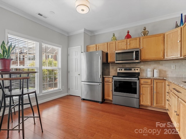 11846 Chelton Ridge Ln, Charlotte, NC 28277 - kitchen featuring ornamental molding, visible vents, wood finished floors, and appliances with stainless steel finishes