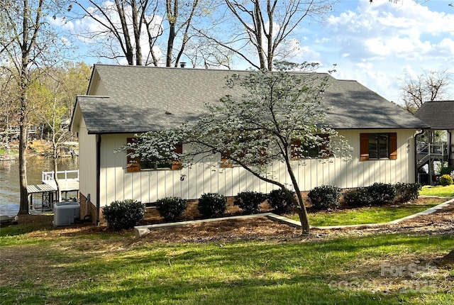 141 Sunrise Pt, New London, NC 28127 - view of side of property with a shingled roof, a yard, and a water view