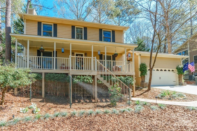 10028 Bora Bora Dr, Tega Cay, SC 29708 - view of front of home with covered porch, stairway, concrete driveway, a chimney, and an attached garage