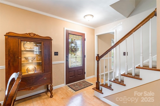 10028 Bora Bora Dr, Tega Cay, SC 29708 - entrance foyer featuring ornamental molding, baseboards, stairway, and light wood finished floors