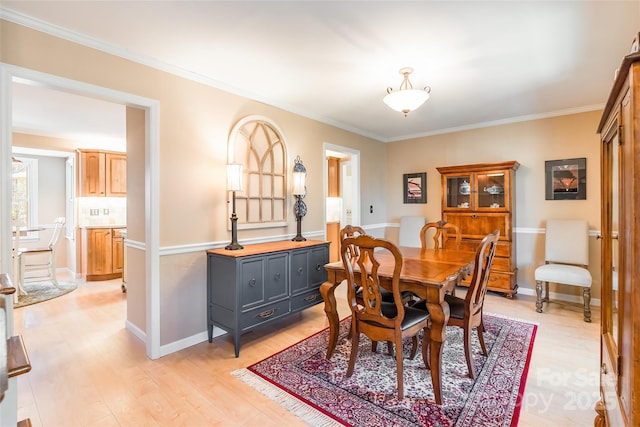 10028 Bora Bora Dr, Tega Cay, SC 29708 - dining area featuring baseboards, crown molding, and light wood-type flooring