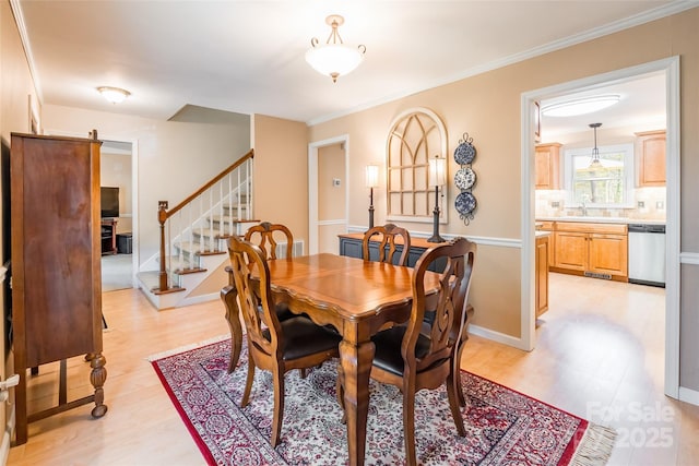 10028 Bora Bora Dr, Tega Cay, SC 29708 - dining area with stairs, light wood-style floors, baseboards, and ornamental molding