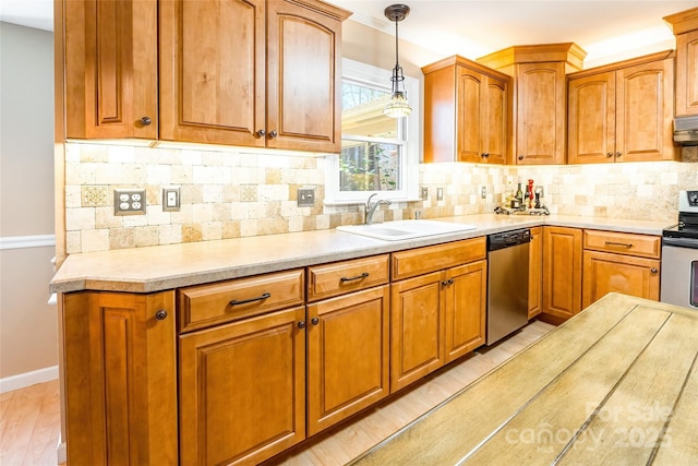 10028 Bora Bora Dr, Tega Cay, SC 29708 - kitchen with decorative backsplash, light countertops, stainless steel appliances, a sink, and pendant lighting