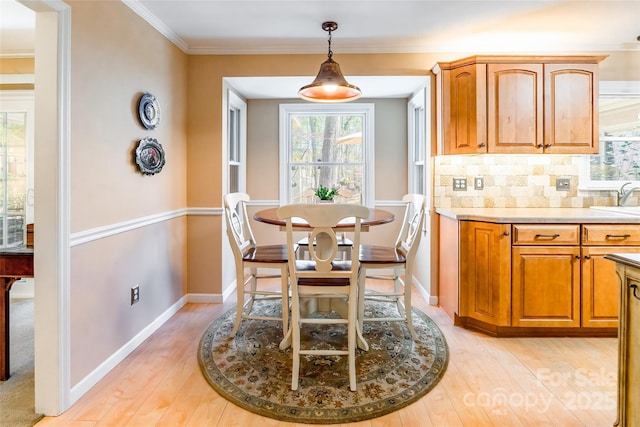 10028 Bora Bora Dr, Tega Cay, SC 29708 - dining room featuring baseboards, light wood-type flooring, and crown molding