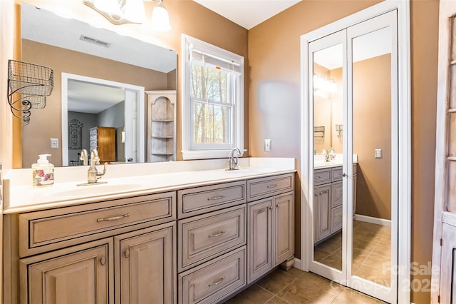 10028 Bora Bora Dr, Tega Cay, SC 29708 - full bathroom featuring a sink, visible vents, double vanity, and tile patterned floors