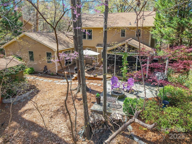 10028 Bora Bora Dr, Tega Cay, SC 29708 - rear view of house featuring a patio, a shingled roof, and a fire pit