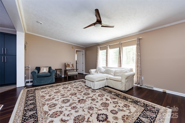 living room featuring dark wood-type flooring, a textured ceiling, crown molding, and ceiling fan