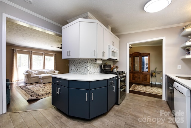 kitchen with blue cabinets, light countertops, white appliances, and wood finish floors
