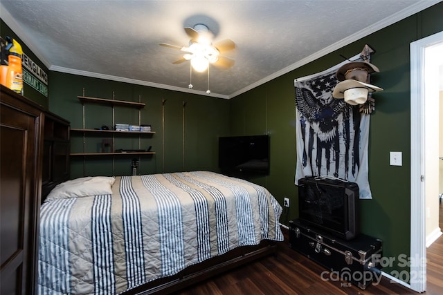 bedroom featuring ornamental molding, ceiling fan, wood finished floors, and a textured ceiling
