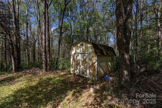 view of shed featuring a forest view