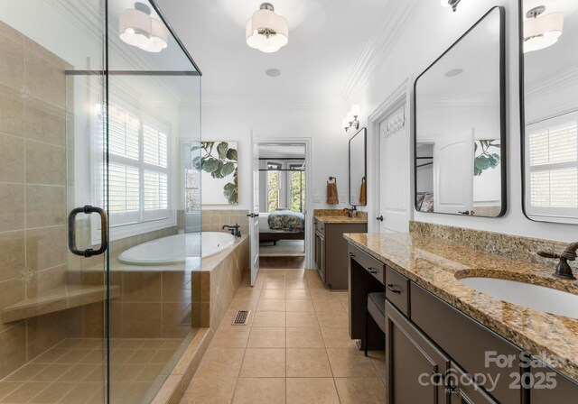 full bath featuring a garden tub, tile patterned flooring, ornamental molding, a sink, and a stall shower