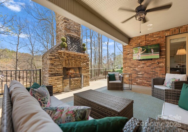 view of patio / terrace featuring an outdoor living space with a fireplace