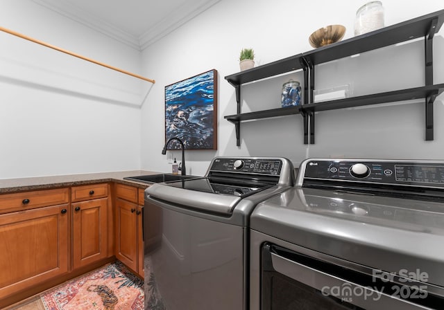 laundry room with washer and dryer, ornamental molding, a sink, and cabinet space