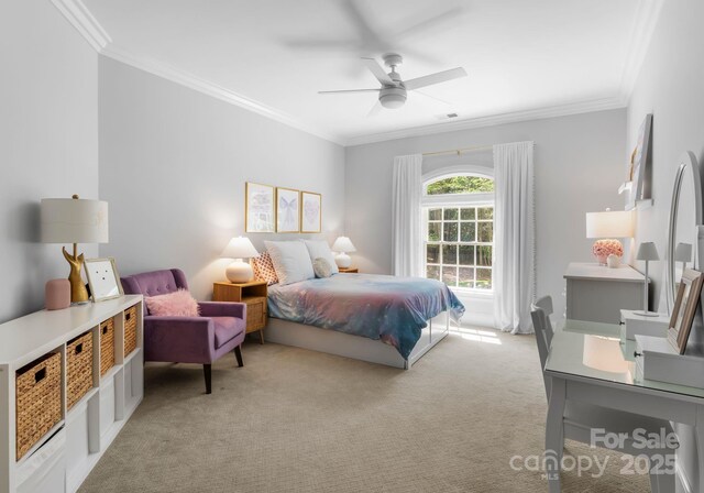 bedroom featuring ornamental molding, a ceiling fan, and light colored carpet