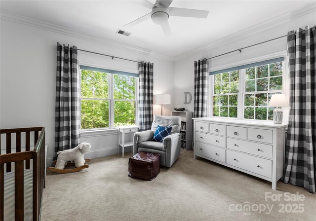 bedroom with ceiling fan, visible vents, crown molding, a nursery area, and light carpet