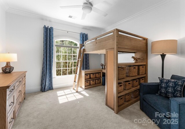 bedroom with crown molding, baseboards, light carpet, and visible vents