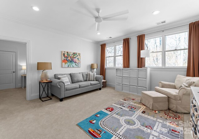 living room featuring a ceiling fan, visible vents, ornamental molding, carpet, and recessed lighting