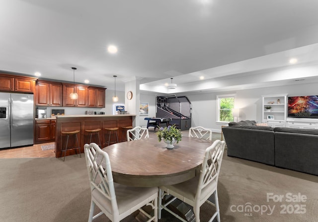 dining area with recessed lighting, ornamental molding, and light carpet