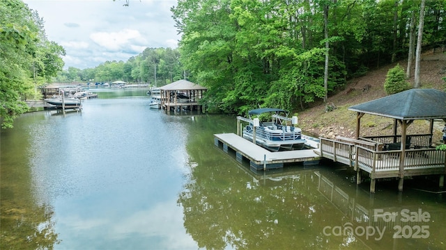 dock area with a water view, a gazebo, and a forest view
