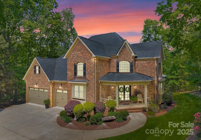 4273 Stormy Pointe Ct, Denver, NC 28037 - traditional-style house featuring french doors, driveway, brick siding, and roof with shingles