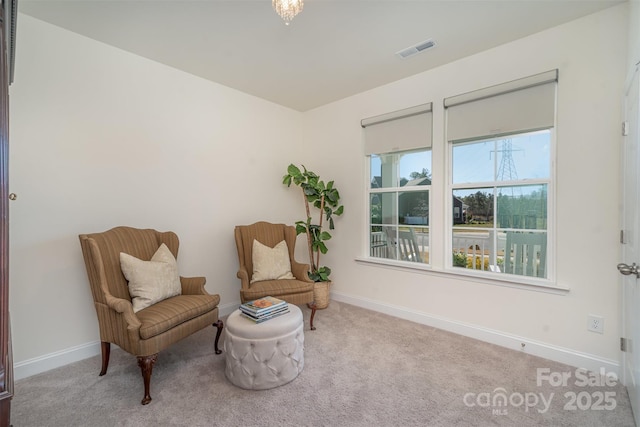 sitting room featuring baseboards, carpet floors, and visible vents