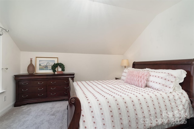 bedroom featuring lofted ceiling and light colored carpet