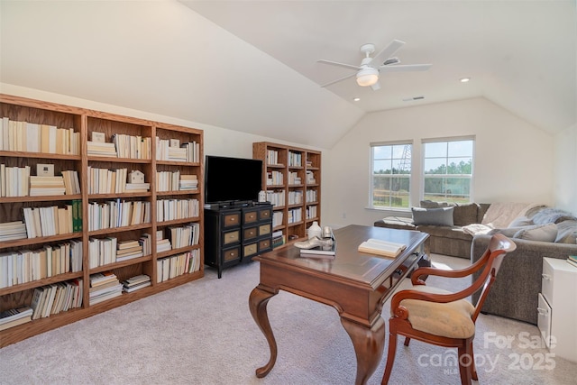 office area with light colored carpet, vaulted ceiling, visible vents, and ceiling fan