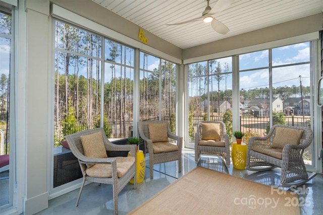 sunroom featuring a ceiling fan