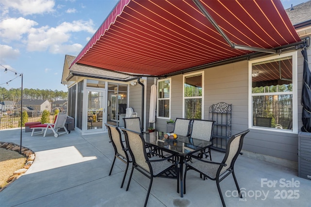 view of patio / terrace with outdoor dining area and fence
