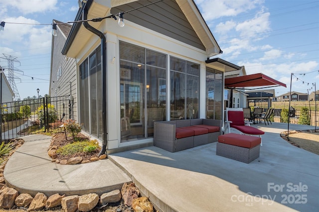 view of patio / terrace with outdoor dining area, outdoor lounge area, a sunroom, and fence