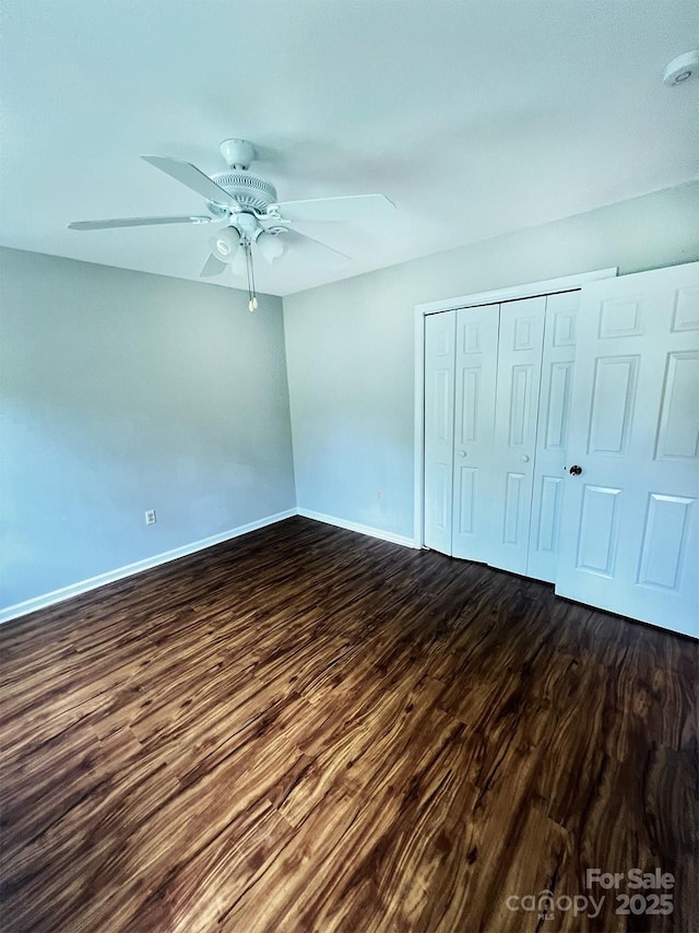 443 Silversmith Ln, Charlotte, NC 28270 - unfurnished bedroom with dark wood finished floors, baseboards, a closet, and a ceiling fan