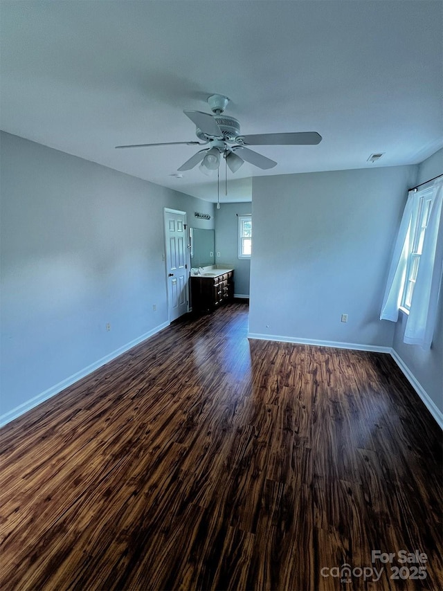 443 Silversmith Ln, Charlotte, NC 28270 - unfurnished living room featuring dark wood-style flooring, a ceiling fan, and baseboards