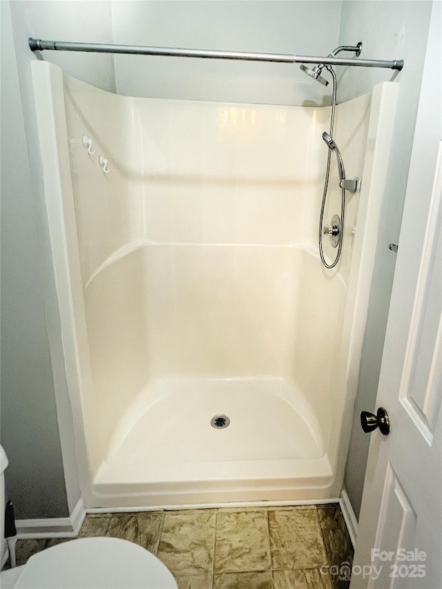 443 Silversmith Ln, Charlotte, NC 28270 - bathroom with baseboards, toilet, and a shower