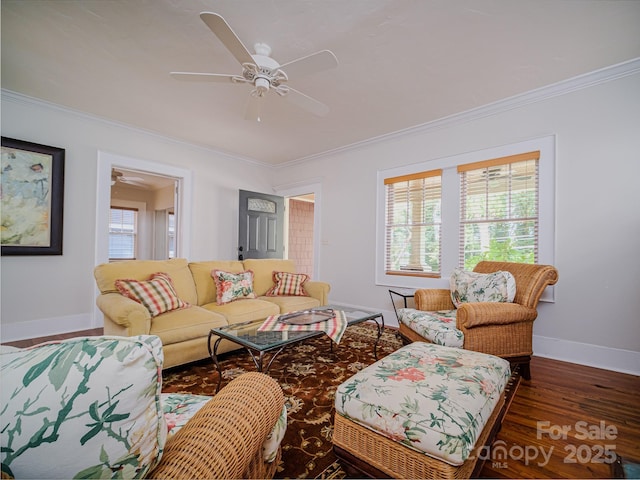 living room with baseboards, ornamental molding, wood finished floors, and a ceiling fan