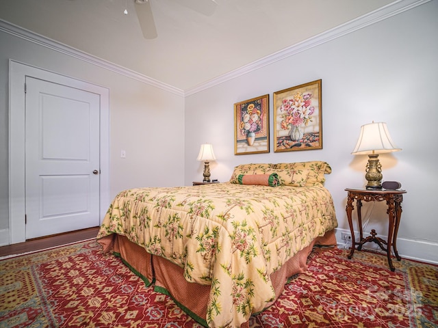 bedroom featuring baseboards, crown molding, wood finished floors, and ceiling fan