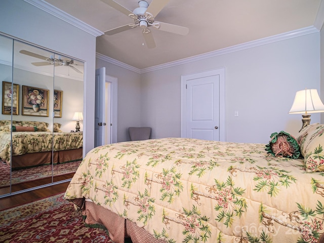 bedroom featuring a closet, wood finished floors, ceiling fan, and ornamental molding