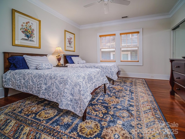 bedroom featuring crown molding, wood finished floors, baseboards, visible vents, and ceiling fan