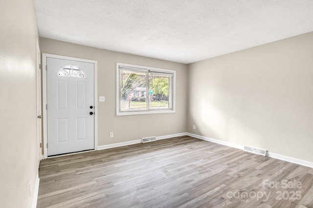 2801 Alleghany St, Charlotte, NC 28208 - entrance foyer with baseboards, visible vents, wood finished floors, and a textured ceiling