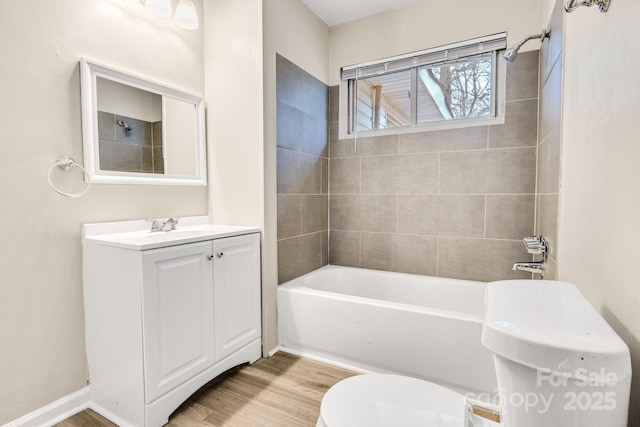 2801 Alleghany St, Charlotte, NC 28208 - full bath featuring toilet, vanity, wood finished floors, washtub / shower combination, and baseboards