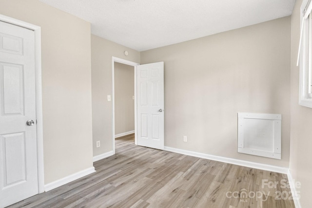 2801 Alleghany St, Charlotte, NC 28208 - unfurnished bedroom featuring baseboards and wood finished floors