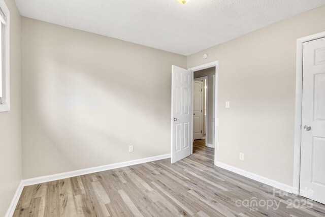 2801 Alleghany St, Charlotte, NC 28208 - unfurnished bedroom with baseboards and light wood-style floors