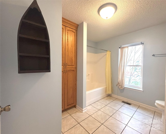 97 Hughes Dr, Maggie Valley, NC 28751 - bathroom with a textured ceiling, tile patterned flooring, toilet, shower / bathtub combination with curtain, and baseboards