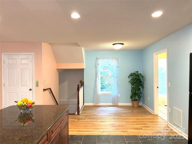 97 Hughes Dr, Maggie Valley, NC 28751 - kitchen with wood finished floors, recessed lighting, dark stone countertops, a textured ceiling, and baseboards