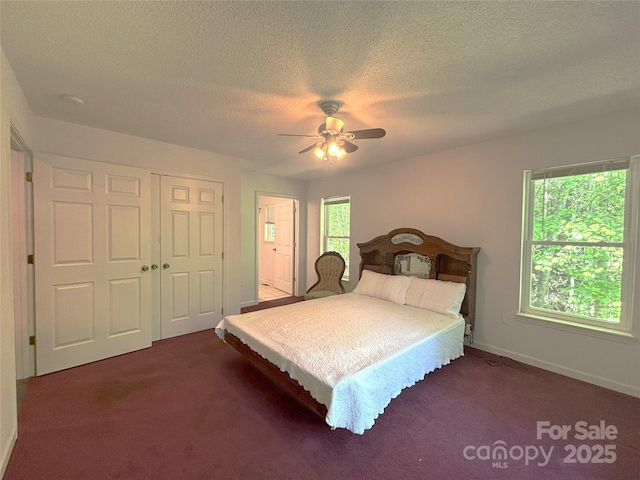 97 Hughes Dr, Maggie Valley, NC 28751 - bedroom with dark carpet, a textured ceiling, a closet, baseboards, and ceiling fan