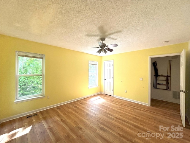 97 Hughes Dr, Maggie Valley, NC 28751 - spare room featuring baseboards, wood finished floors, a textured ceiling, and ceiling fan