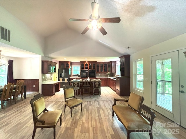 97 Hughes Dr, Maggie Valley, NC 28751 - living area featuring light wood-style flooring, plenty of natural light, a ceiling fan, and high vaulted ceiling