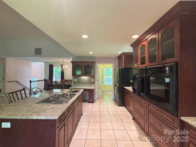 97 Hughes Dr, Maggie Valley, NC 28751 - kitchen with black appliances, recessed lighting, glass insert cabinets, light tile patterned floors, and a sink