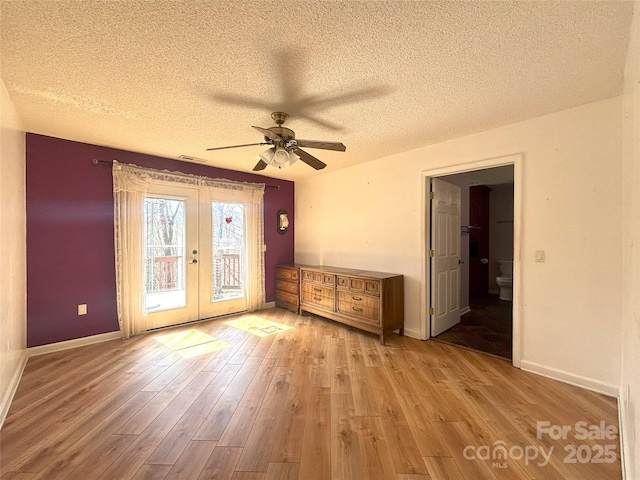 97 Hughes Dr, Maggie Valley, NC 28751 - spare room featuring french doors, a ceiling fan, a textured ceiling, hardwood / wood-style floors, and baseboards