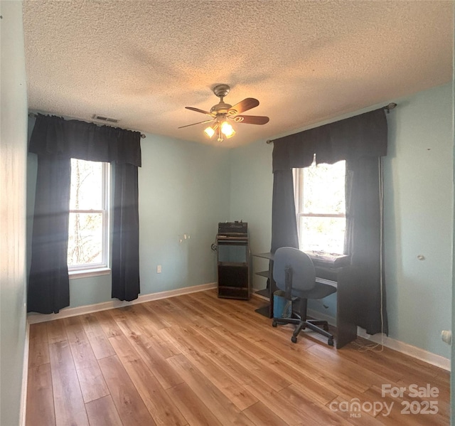 97 Hughes Dr, Maggie Valley, NC 28751 - home office featuring a textured ceiling, light wood finished floors, a ceiling fan, and baseboards